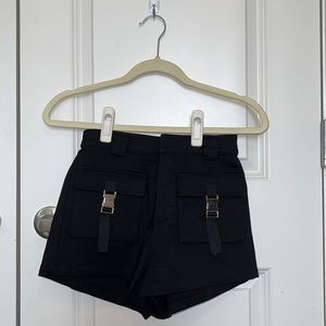 Black shorts with buckles.